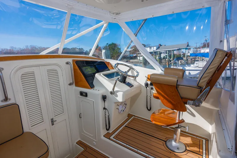 Slide: The Image of 1987 Custom Carolina Island Boatworks 34 Express helm with wooden seat and modern controls. - 13