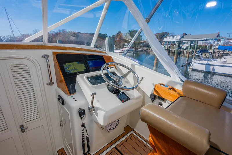 Slide: The Image of Helm of 1987 Custom Carolina Island Boatworks 34 Express with navigation screens and steering wheel. - 14