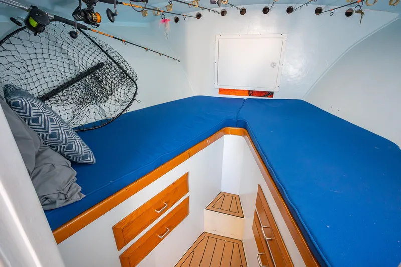 Slide: The Image of Cozy cabin interior of 1987 Custom Carolina Island Boatworks 34 Express with blue cushions. - 22