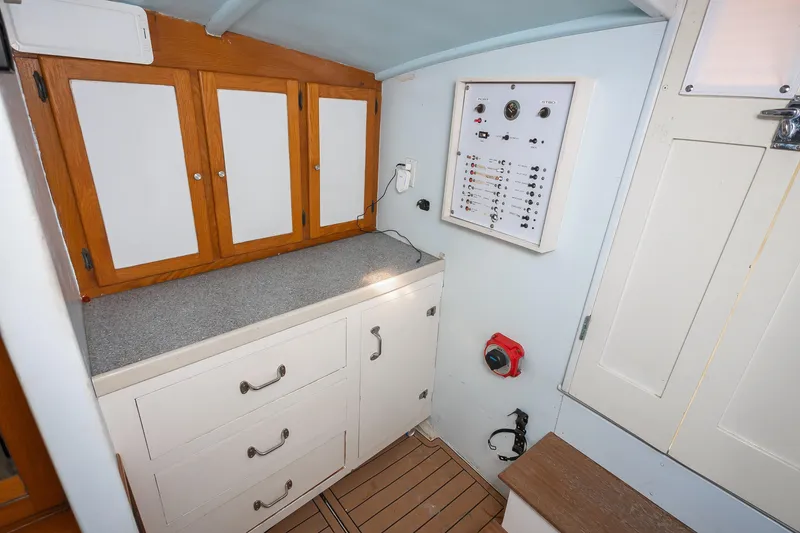 Slide: The Image of Interior of 1987 Custom Carolina Island Boatworks 34 Express, featuring cabinets and control panel. - 20