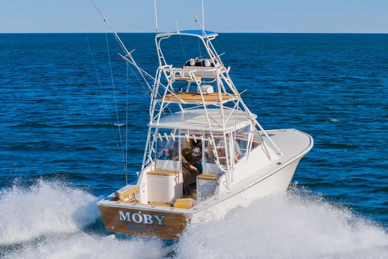 Slide: The Image of 1987 Custom Carolina Island Boatworks 34 Express cruising on open sea. - 2