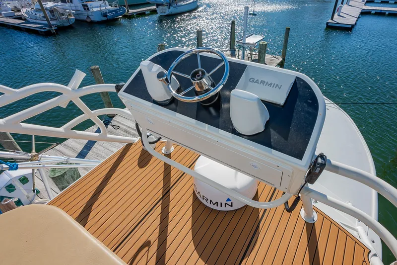 Slide: The Image of Helm of 1987 Custom Carolina Island Boatworks 34 Express with Garmin equipment, docked at marina. - 18