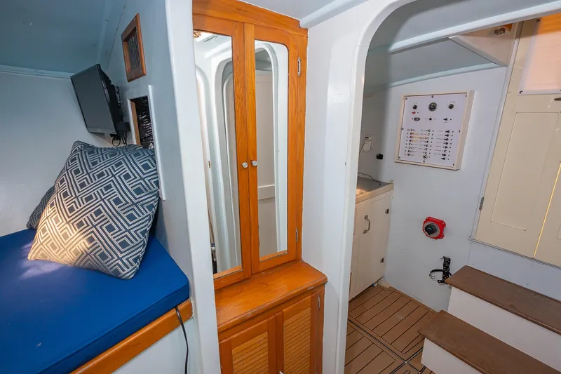 Slide: The Image of Interior of 1987 Custom Carolina Island Boatworks 34 Express, featuring seating, cabinetry, and control panel. - 21