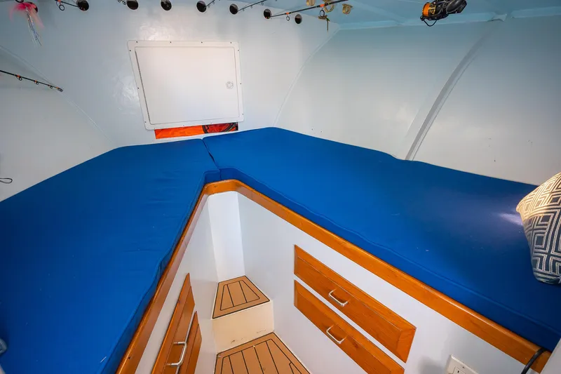 Slide: The Image of Interior cabin of 1987 Custom Carolina Island Boatworks 34 Express with blue bedding. - 23