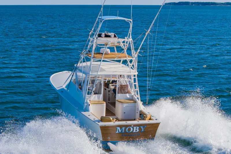 Slide: The Image of 1987 Custom Carolina Island Boatworks 34 Express cruising on open sea. - 4