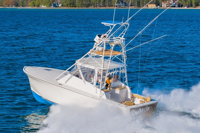 Slide: The Image of 1987 Custom Carolina Island Boatworks 34 Express cruising on open water. - 5