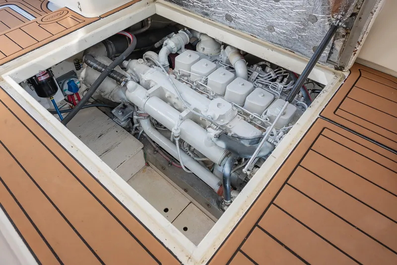 Slide: The Image of Engine compartment of 1987 Custom Carolina Island Boatworks 34 Express, showcasing detailed mechanics. - 28