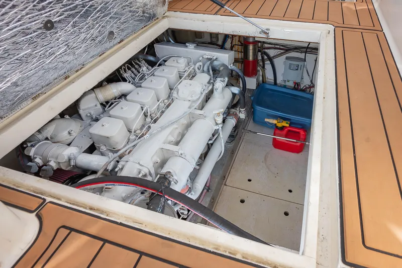 Slide: The Image of Engine compartment of 1987 Custom Carolina Island Boatworks 34 Express, showcasing detailed machinery. - 29