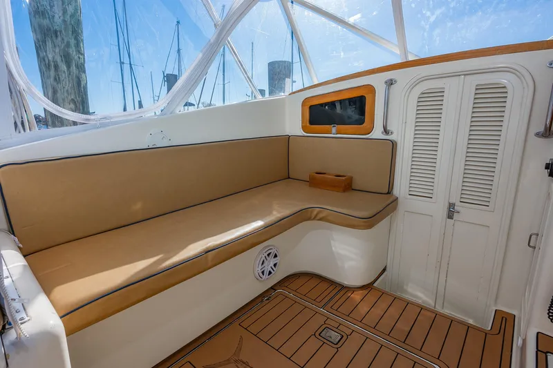 Slide: The Image of 1987 Custom Carolina Island Boatworks 34 Express interior with tan seating and wooden accents. - 15