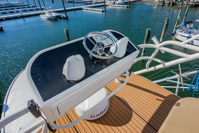 Slide: The Image of Helm of 1987 Custom Carolina Island Boatworks 34 Express at marina. - 17