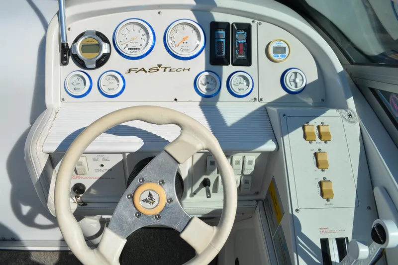 Slide: The Image of Dashboard of a 2000 Formula 271 FASTech boat with gauges and steering wheel. - 10