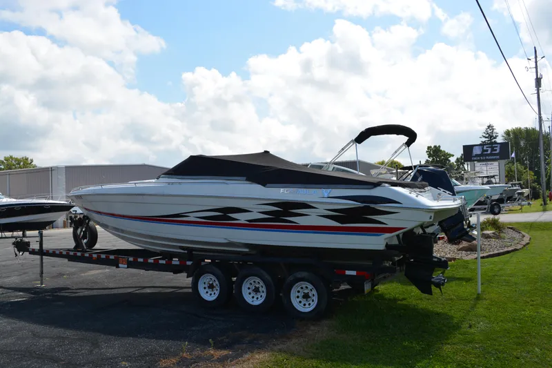 Slide: The Image of 2000 Formula 271 FASTech boat on trailer, parked outdoors under a cloudy sky. - 3