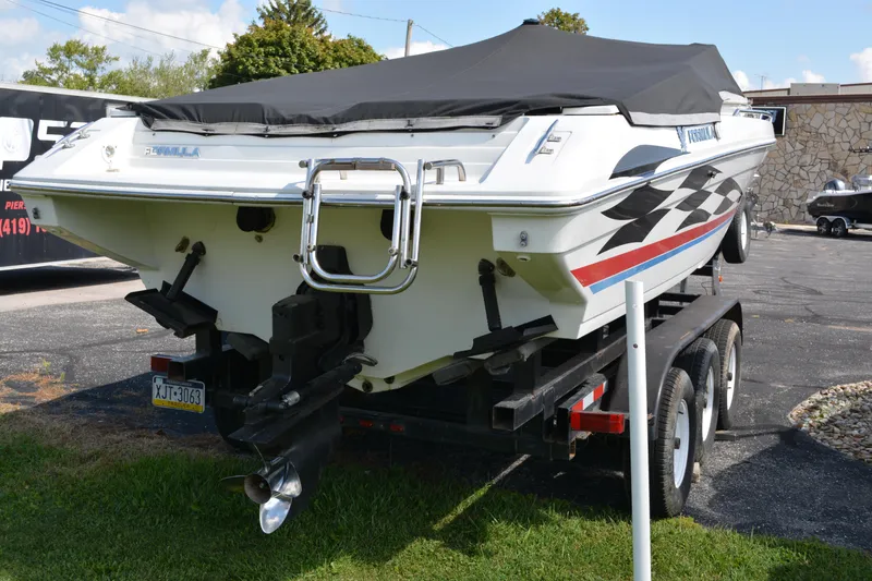 Slide: The Image of 2000 Formula 271 FASTech boat on trailer, covered, with checkered flag design. - 5