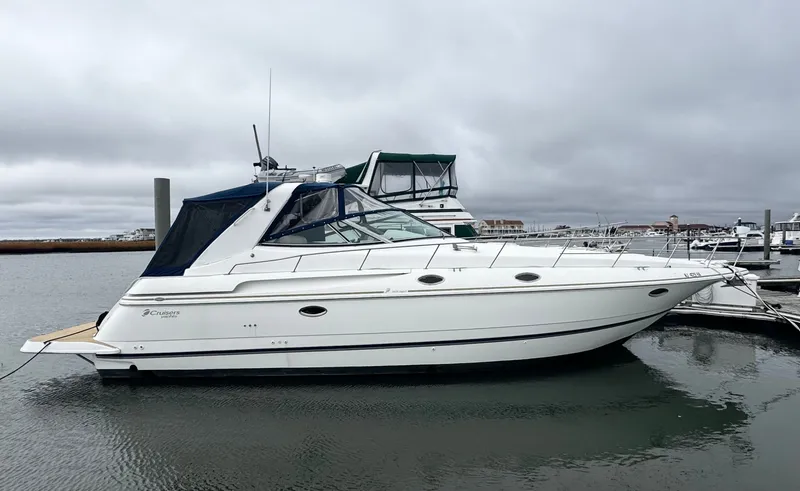 The Image of 1998 Cruisers Yachts 3870 Esprit docked in a marina under cloudy skies. - 0