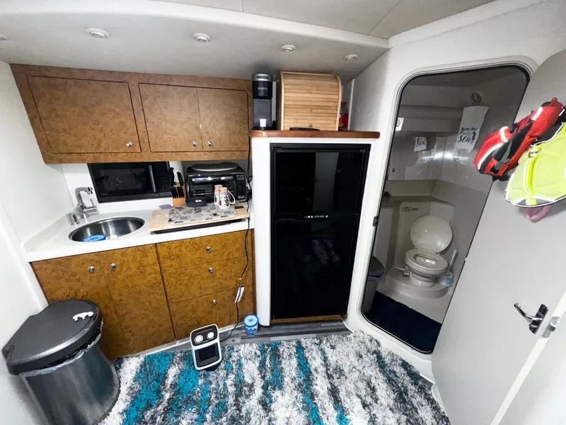 Slide: The Image of 1998 Cruisers Yachts 3870 Esprit interior with kitchenette and bathroom. - 12