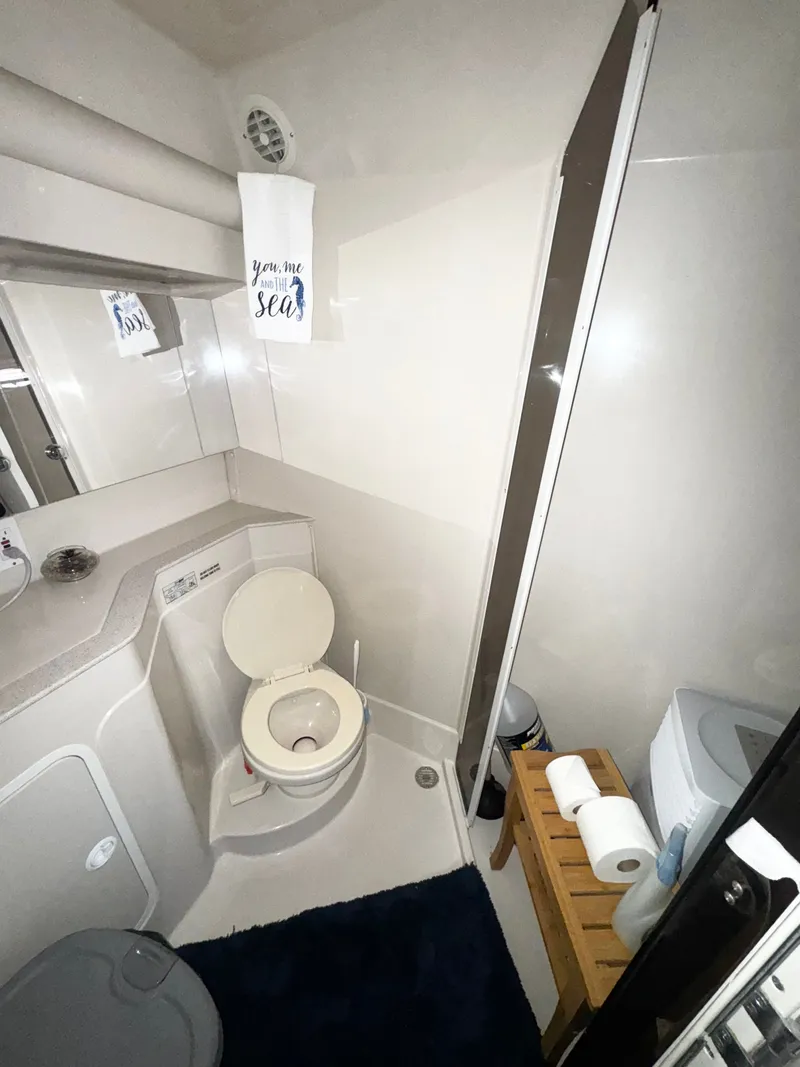 Slide: The Image of Bathroom interior of 1998 Cruisers Yachts 3870 Esprit with toilet and towel. - 13