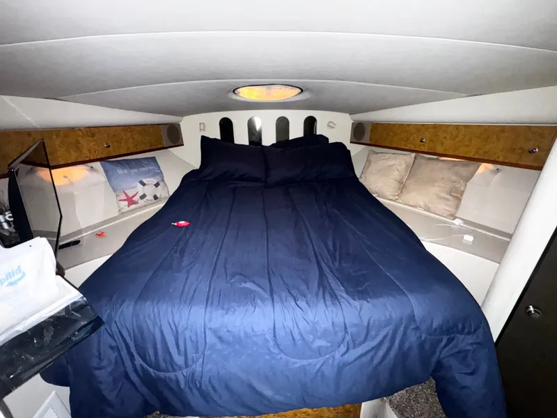Slide: The Image of 1998 Cruisers Yachts 3870 Esprit cabin with cozy bed and blue bedding. - 15