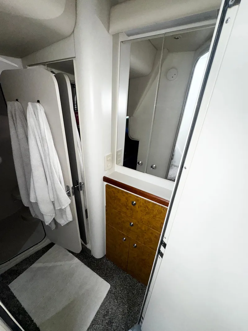 Slide: The Image of 1998 Cruisers Yachts 3870 Esprit bathroom with mirror, towels, and wooden cabinet. - 18