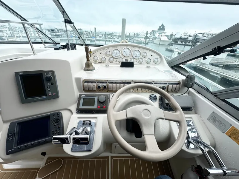 Slide: The Image of 1998 Cruisers Yachts 3870 Esprit helm with navigation instruments and steering wheel at marina. - 4