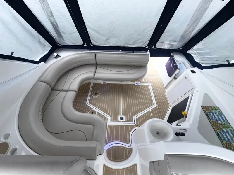 Slide: The Image of 1998 Cruisers Yachts 3870 Esprit interior with curved seating and wood-patterned flooring. - 5