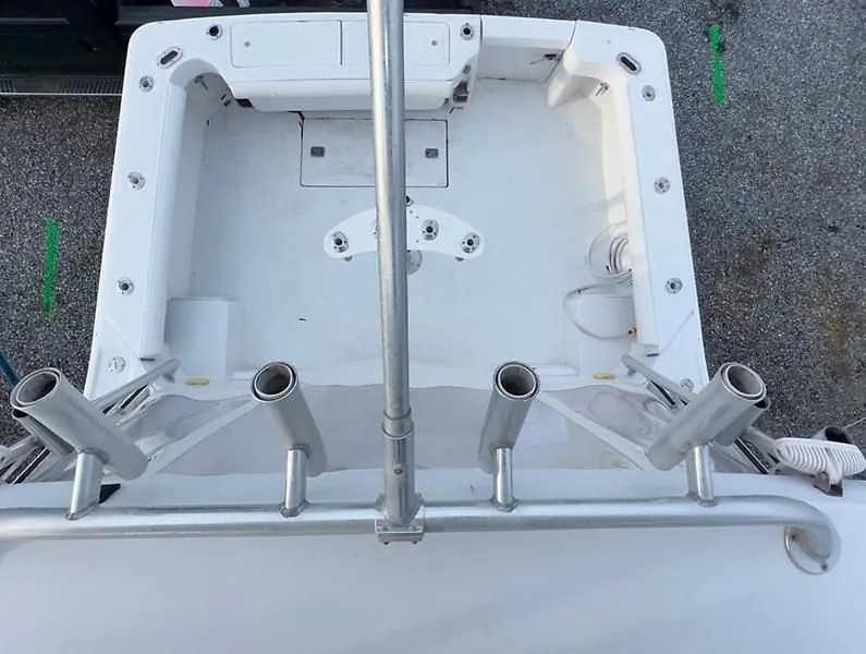 Slide: The Image of 1998 Luhrs 32 Express boat deck with rod holders and storage compartments. - 13