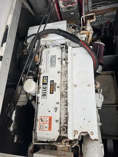 Slide: The Image of Caterpillar 3116 engine in a 1998 Luhrs 32 Express boat, showing detailed components. - 14