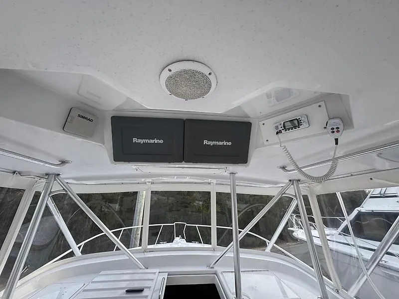 Slide: The Image of 1998 Luhrs 32 Express boat interior with Raymarine navigation equipment and Simrad device. - 9