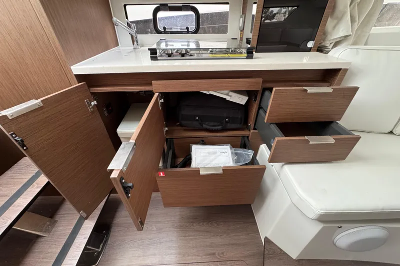 Slide: The Image of Interior of 2025 Jeanneau Leader 10.5 WA Series 2, featuring modern wood finish and cozy cabin. - 16