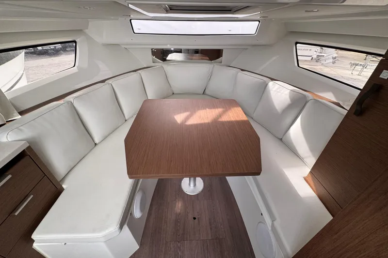 Slide: The Image of 2025 Jeanneau Leader 10.5 WA Series 2 yacht docked at marina, featuring spacious sunbathing area. - 19