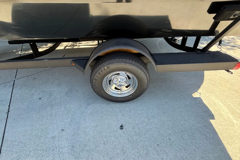 Slide: The Image of Trailer wheel of 2026 Tracker Pro Guide V-175 WT on concrete surface. - 15