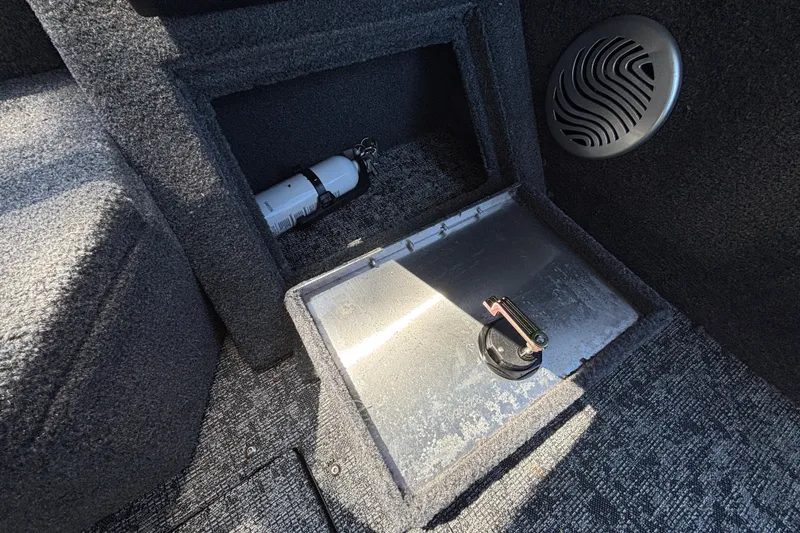 Slide: The Image of Interior of 2026 Tracker Pro Guide V-175 WT boat, featuring storage compartment and speaker. - 45