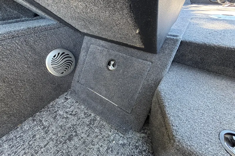 Slide: The Image of Interior of 2026 Tracker Pro Guide V-175 WT boat, featuring speaker and storage compartment. - 48