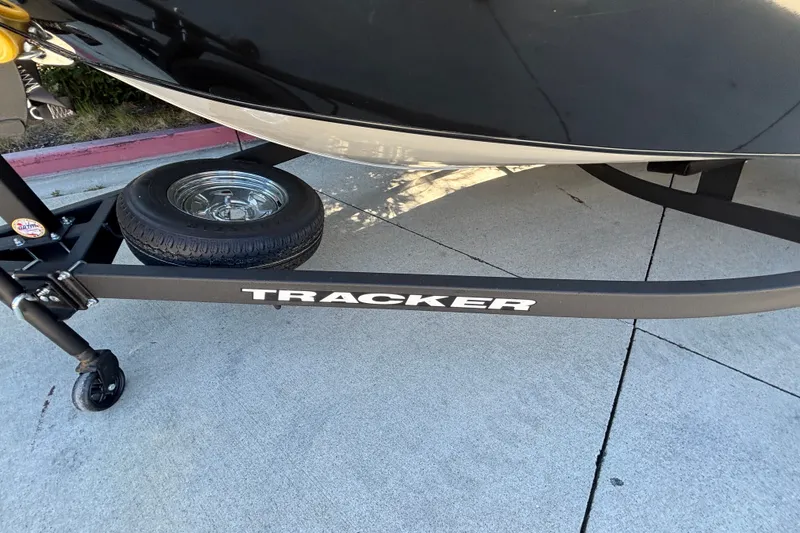 Slide: The Image of Trailer of 2026 Tracker Pro Guide V-175 WT boat on pavement. - 16