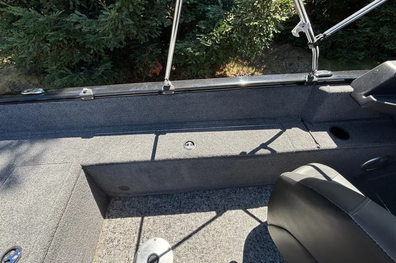 Slide: The Image of Interior view of 2026 Tracker Pro Guide V-175 WT boat with seating and carpeted flooring. - 43