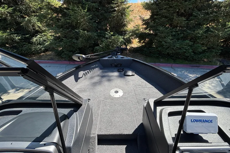 Slide: The Image of 2026 Tracker Pro Guide V-175 WT boat interior with Lowrance equipment, surrounded by trees. - 20