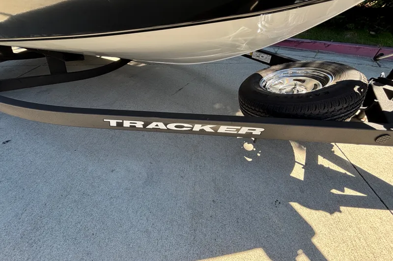 Slide: The Image of 2026 Tracker Pro Guide V-175 WT boat trailer with visible tire on concrete surface. - 17