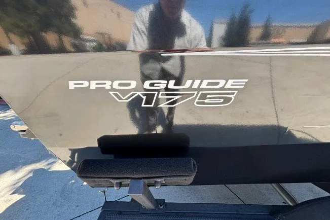 Slide: The Image of 2026 Tracker Pro Guide V-175 WT boat exterior with model branding. - 31