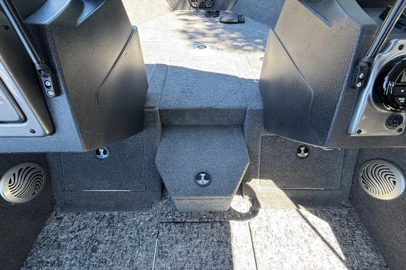 Slide: The Image of Interior view of 2026 Tracker Pro Guide V-175 WT boat, featuring carpeted flooring and storage compartments. - 24