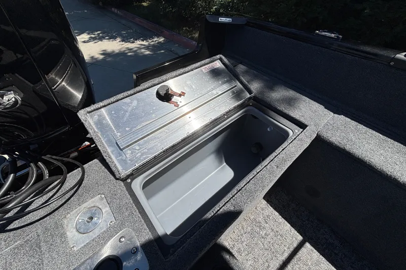 Slide: The Image of 2026 Tracker Pro Guide V-175 WT boat storage compartment with open lid, showing interior space. - 25