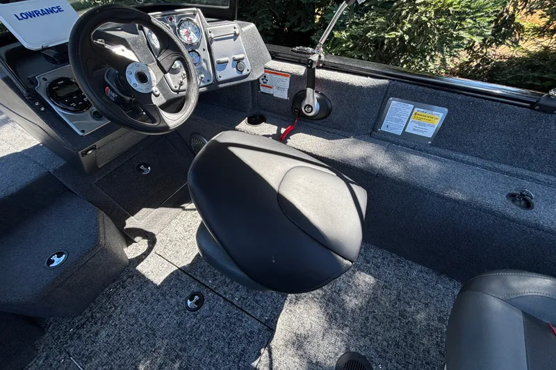 Slide: The Image of Interior of 2026 Tracker Pro Guide V-175 WT boat with steering wheel and seating. - 40