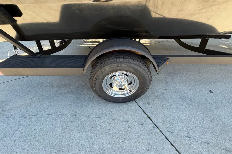 Slide: The Image of 2026 Tracker Pro Guide V-175 WT trailer wheel on concrete surface. - 18