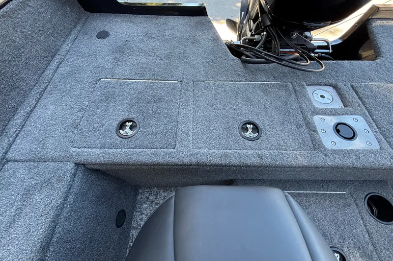 Slide: The Image of 2026 Tracker Pro Guide V-175 WT boat interior with carpeted deck and storage compartments. - 30