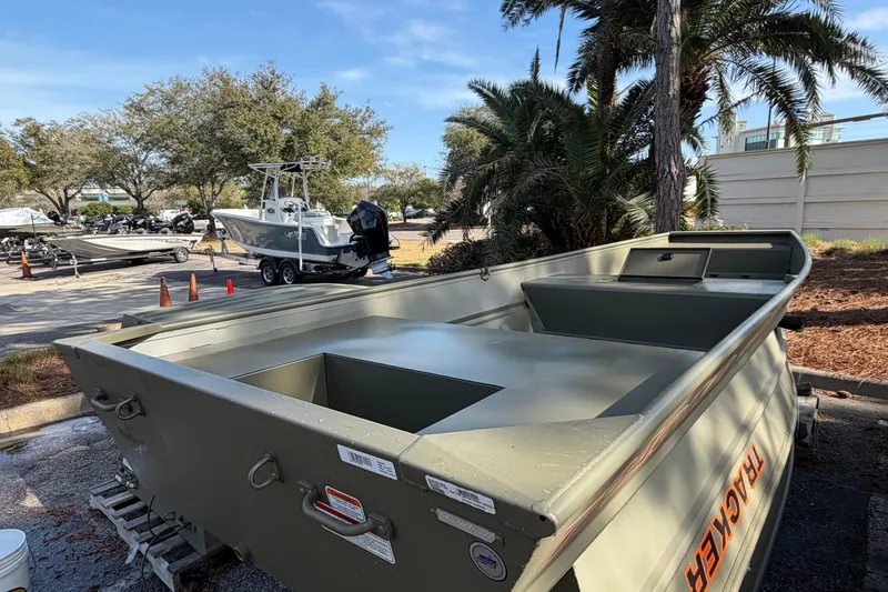 The Image of 2026 Tracker Grizzly 15 Jon boat parked outdoors near palm trees. - 0