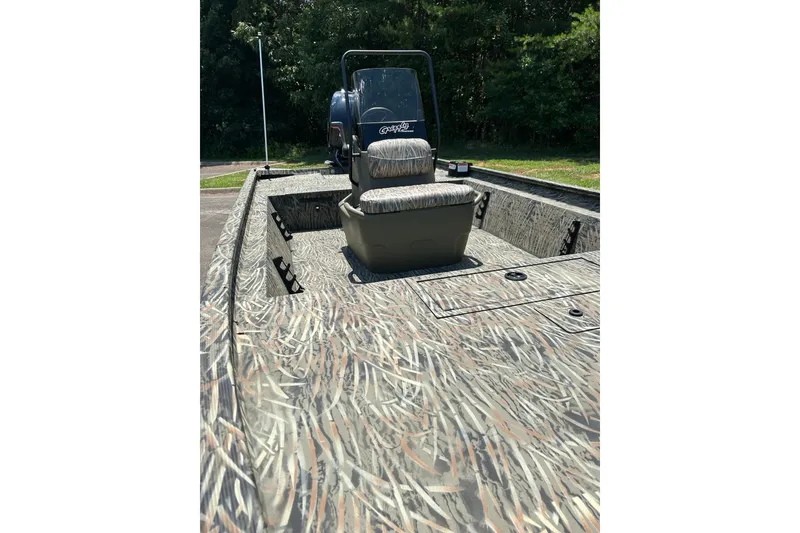 Slide: The Image of 2026 Tracker Grizzly 1860 CC boat with camouflage design, featuring central console and seating. - 63