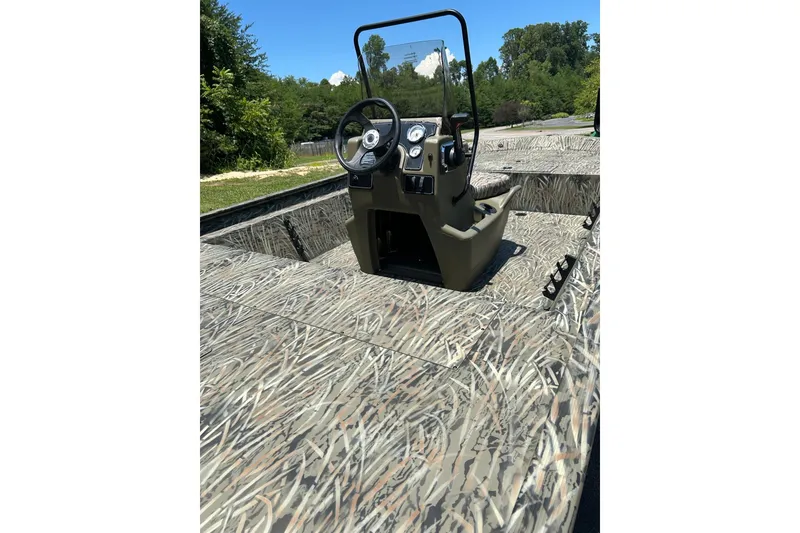 Slide: The Image of 2026 Tracker Grizzly 1860 CC boat with camo design and central console. - 64