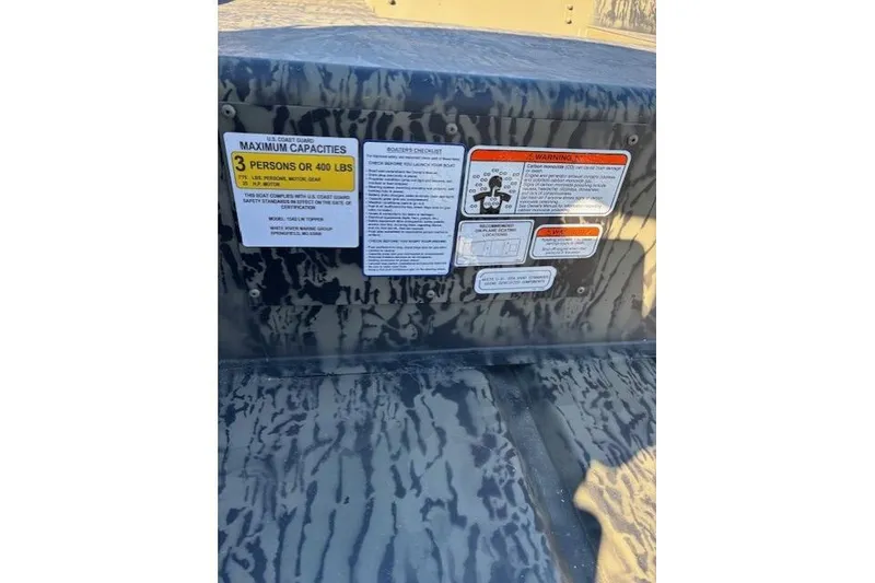 Slide: The Image of 2026 Tracker Grizzly 15 Jon boat capacity and safety labels, maximum 3 persons or 400 lbs. - 2