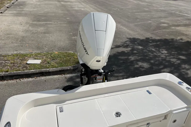 Slide: The Image of 2025 Ranger 2360 Bay boat with Mercury outboard engine in a parking area. - 18