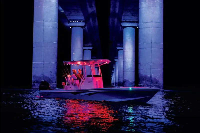 Slide: The Image of 2025 Ranger 2360 Bay boat with white leather seats and Mercury engine. - 6