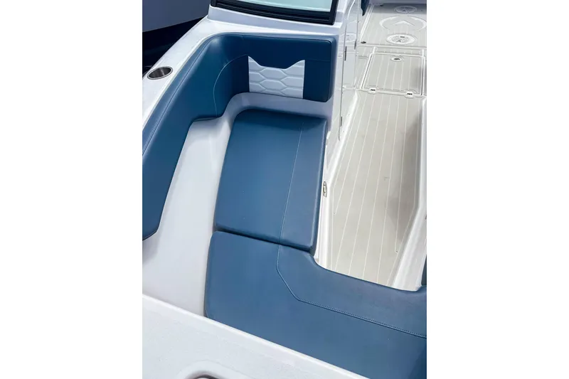 Slide: The Image of 2024 Aquasport AS DC 22 boat interior with blue seating and white deck. - 23
