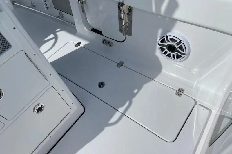 Slide: The Image of 2026 Sportsman Open 262 Center Console boat interior with storage compartments and speaker. - 11